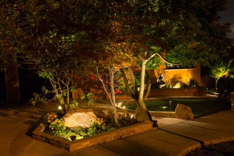 Outdoor lighting shines on a landscape bed in Springfield, MO