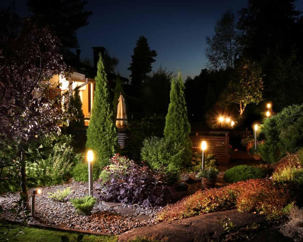 Picture of a beautifully illuminated garden path, highlighting the lighting services offered by Custom Creations in Marshfield, MO
