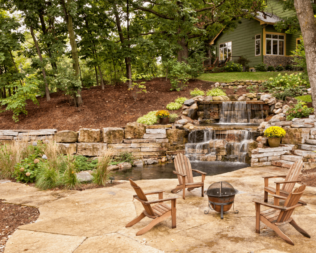 Photo showcasing a serene backyard water feature surrounded by lush, locally suitable plants, representing the water features that can be installed by Custom Creations in Springfield, MO.